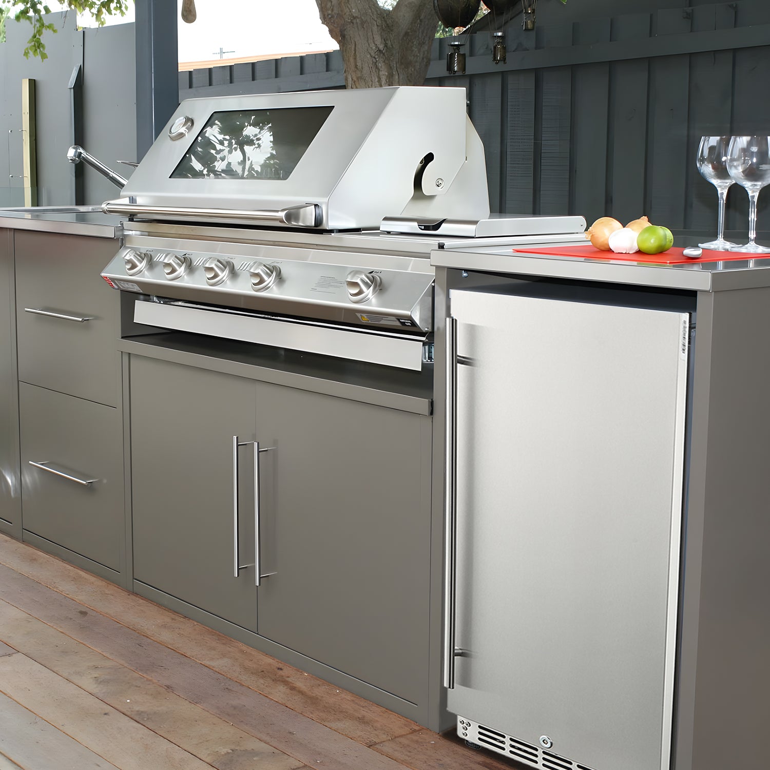 Side view of an outdoor kitchen setup with a 3.2 Cu Ft Undercounter Beverage Refrigerator installed beside a barbecue grill