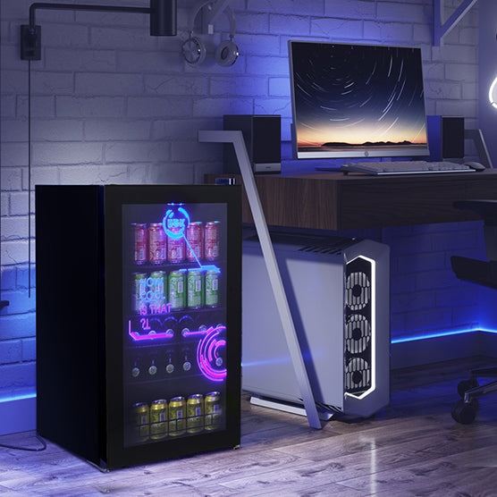 Side view of a cyberpunk style room with a 3.5 Cu Ft Cyberpunk Glass Door Beverage Fridge installed next to a computer setup
