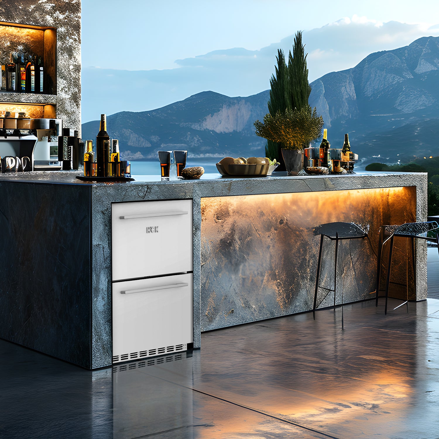View of a bar setup featuring a 5.12 Cu Ft Undercounter Beverage Outdoor Refrigerator Drawer Design installed beneath the table. The table is decorated with bottles of wine and decorations