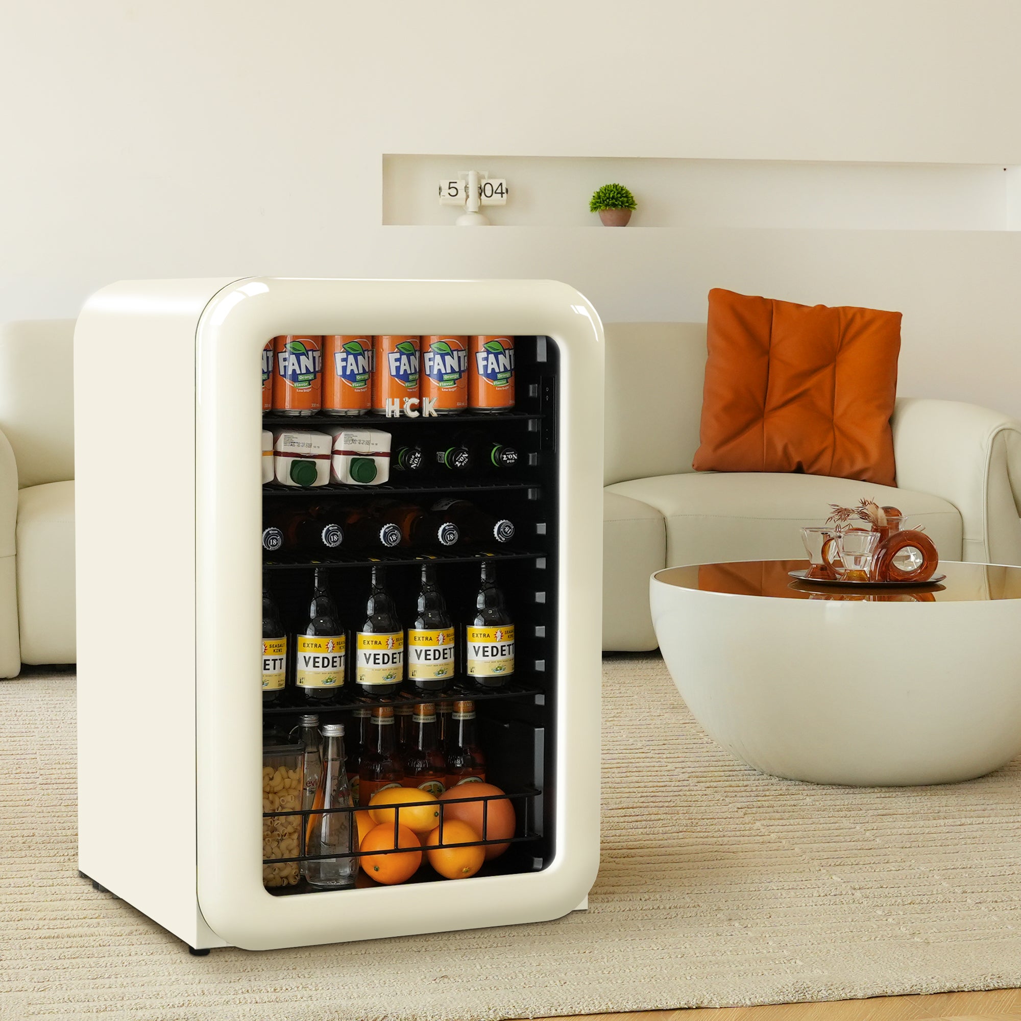 Front view of a living room with a 4.1 Cu Ft Iconic Retro Style Beverage Fridge 49 Bottles placed in front of a sofa